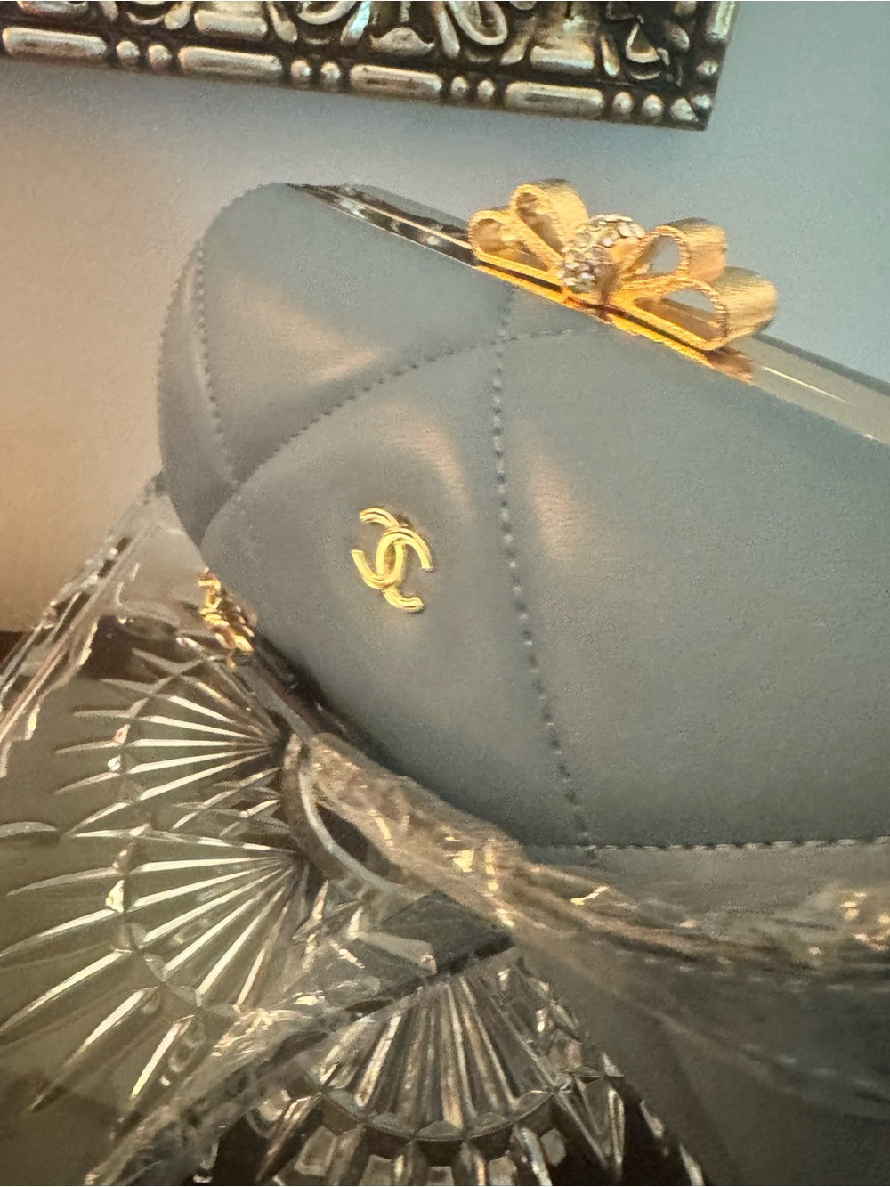 Gray Quilted Shoulder Bag with Gold Bow Clasp